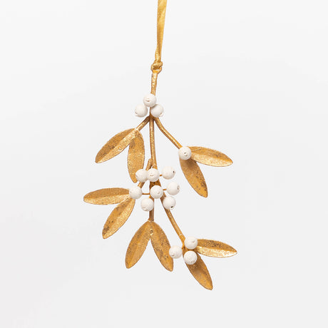Add a little holiday romance to the tree with our Mistletoe Metal Ornament. Inspired by vintage botanical decorations, this delicate golden mistletoe is beautifully handcrafted with embossed iron leaves, hand-cast resin details, and a softly aged gilt finish.