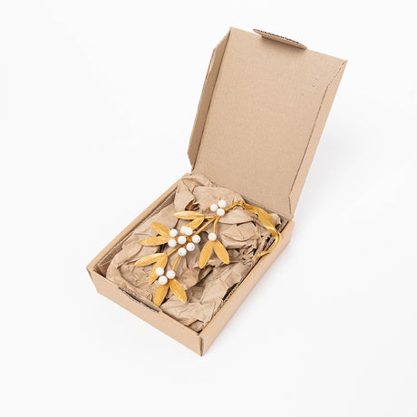 Add a little holiday romance to the tree with our Mistletoe Metal Ornament. Inspired by vintage botanical decorations, this delicate golden mistletoe is beautifully handcrafted with embossed iron leaves, hand-cast resin details, and a softly aged gilt finish.
