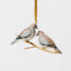 Two little doves, perched side by side. Our Mourning Doves Ornament captures one of nature’s sweetest pairings, with two beautifully hand-painted birds resting together on a delicate gold-toned metal branch.
