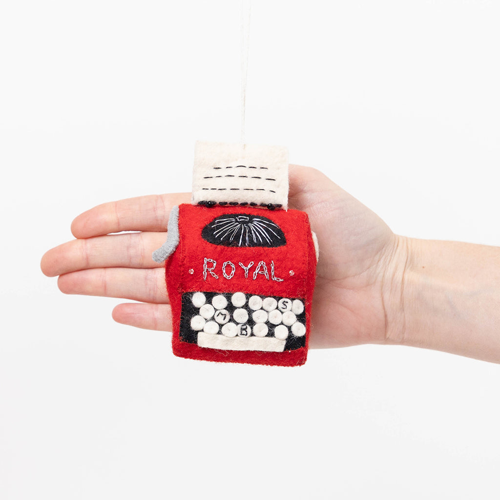 Vintage-inspired red typewriter ornament handcrafted from felted wool, based on the 1955 Royal Quiet De Luxe. Great gift for authors, poets, and creatives.

