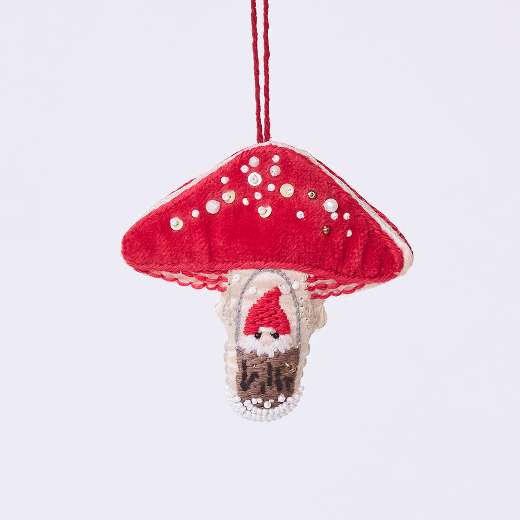 Handmade satin and velvet Mushroom Beaded Ornament from Craftspring, featuring intricate beaded and embroidered details with a gnome peeking out of a door on one side of the mushroom—heirloom-quality Christmas decor, ethically crafted by artisans using sustainable materials.