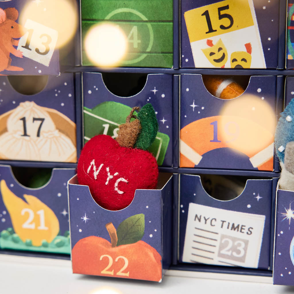 Close-up of NYC Advent Calendary - Countdown to Holiday Magic in iconic style, with our handmade New York City Advent calendar featuring 24 miniature felt ornaments inspired by the landmarks, foods, neighborhoods, and wonderfully quirky icons of NYC.