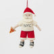 Celebrate Christmas in the Big Apple with our handmade NYC Santa Ornament, featuring Santa dressed like a true New Yorker with an NYC tee and a classic slice of New York pizza.

Who says Santa only runs on milk and cookies? After a busy night delivering gifts across the five boroughs, he's treating himself to a well-earned slice of New York pizza.