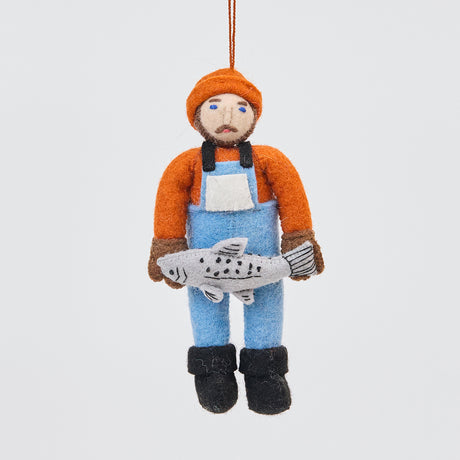 Handmade felt Old Man Salmon ornament from Craftspring, featuring a fisherman in a blue bib holding a silver salmon—heirloom-quality Christmas decor with embroidered details, ethically handmade by artisans using sustainable wool.