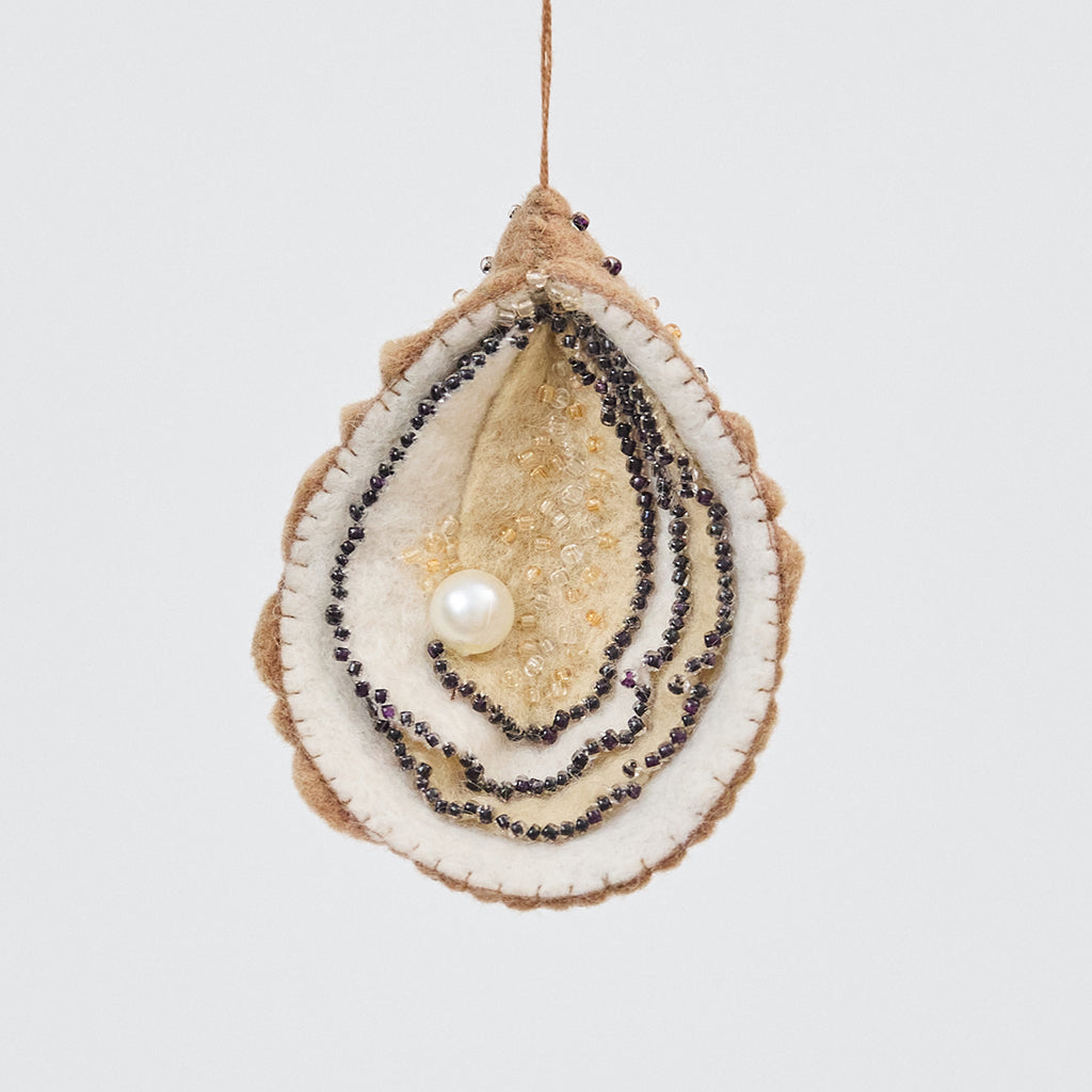 Handmade felt Oyster Christmas ornament from Craftspring, featuring a beaded pearl and intricate beaded and embroidered details—ethically crafted by artisans using sustainable wool.