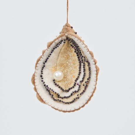 Handmade felt Oyster Christmas ornament from Craftspring, featuring a beaded pearl and intricate beaded and embroidered details—ethically crafted by artisans using sustainable wool.
