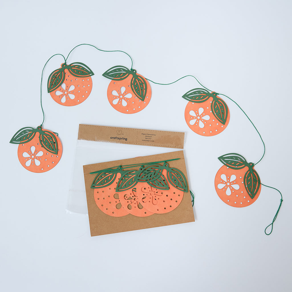 Paper Clementine Garland — set of 2 handmade garlands, each with 5 clementines featuring leaves and intricate cutout details, ethically handmade by artisans from recycled cotton waste — festive Christmas, holiday, and Lunar New Year decor, perfect for joyful gifting.