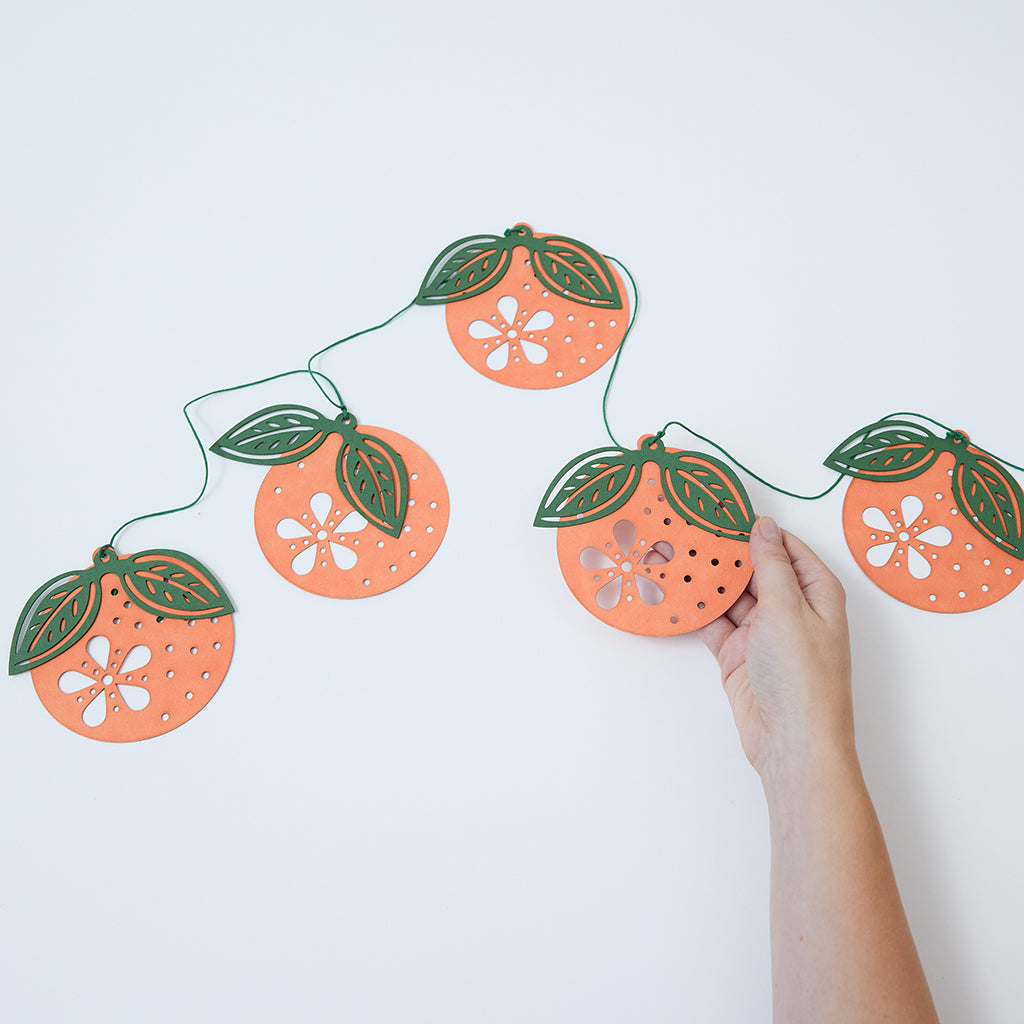 Paper Clementine Garland — set of 2 handmade garlands, each with 5 clementines featuring leaves and intricate cutout details, ethically handmade by artisans from recycled cotton waste — festive Christmas, holiday, and Lunar New Year decor, perfect for joyful gifting.