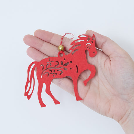 Craftspring’s Paper Horse Ornament displayed in front of a hand to show its size—delicately crafted from paper with intricate Lunar New Year motifs, heirloom-quality holiday decor, ethically handmade by artisans.
