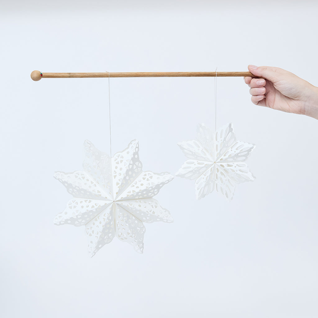 Craftspring’s Paper Snowflakes Christmas Ornaments — Set of 2, large white snowflakes with intricate cutout patterns, one slightly larger than the other —  ethically handmade by artisans from recycled cotton waste.