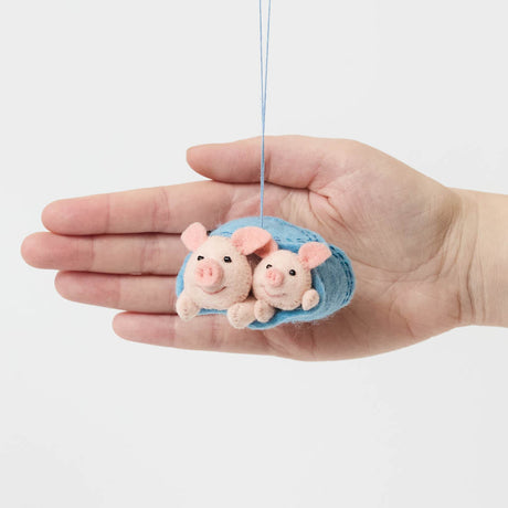Cozy, cuddly, and completely irresistible—our Pigs in a Blanket Ornament is here to wrap your holidays in pure joy. Featuring a sweet pig parent and baby snuggled snugly inside a soft blue “blanket,” this playful design brings together comfort, humor, and heartfelt connection in the most delightful way.