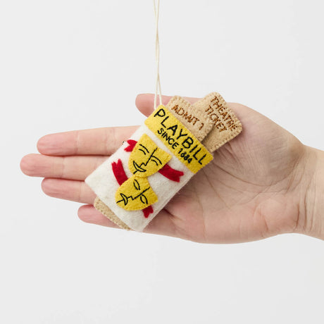 Celebrate the magic of Broadway with our handmade Playbill Ornament, inspired by the iconic theater program and finished with a hidden "Bravo!" message to honor every unforgettable performance.