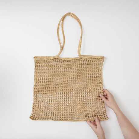 Effortlessly stylish and endlessly versatile, our Raffia Tote Bag is designed for beach days, market strolls, weekend getaways, and everyday adventures. Hand-crocheted from natural raffia fibers, this lightweight tote combines timeless coastal style with practical functionality, creating a beautiful accessory you'll reach for season after season.