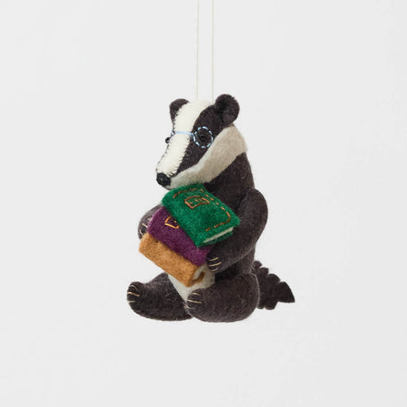 Reminiscent of Wind in the Willows, or a character from Beatrix Potter, this studious little badger is just darling! You are sure to fall in love with his cute embroidered spectacles, pile of books and just darling handcrafter details.