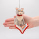 Handmade gray felted cat ornament, depicted mid-chapter in a fishy tale. The playful kitty wears a jingly collar and is fully immersed in its literary adventure. Crafted from natural wool, this whimsical ornament celebrates the love of books and cats, perfect for cat lovers, readers, and bookshop fans. Comes ready to hang with a string, adding a charming touch to any tree or reading nook.