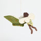 Handmade felt ornament of a fairy with delicate wings and a leafy green tunic, reading an oversized open book embroidered with whimsical details. Crafted from merino-blended wool, this limited-edition ornament is full of storybook charm. Perfect for fairy collectors, book lovers, and dreamers, it brings a magical, literary touch to bookshelves, holiday trees, or cozy reading spaces. Ready to hang with a string attached.