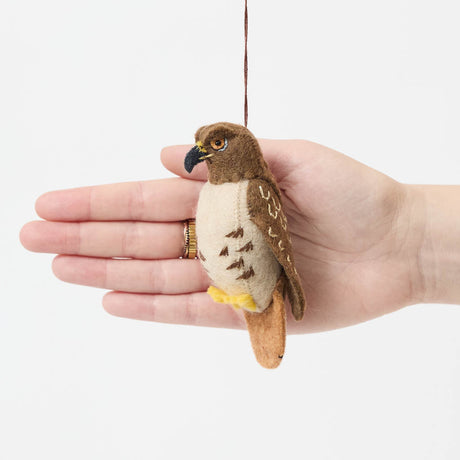 Celebrate the beauty of North American wildlife with this handmade red-tailed hawk ornament, a nature-inspired decoration perfect for bird lovers and rustic holiday decor.