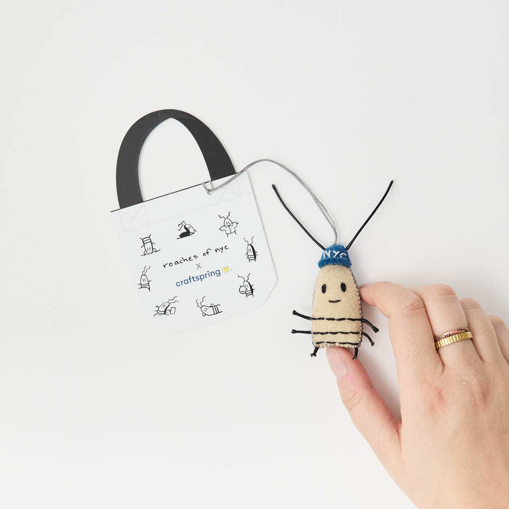 The one New York City roach you'll actually want to take home! Meet our Roach Bag Charm, a cheeky little tribute to the city that never sleeps and its most infamous residents. Created in collaboration with Roaches of NYC, the whimsical world of artist JG Debray, this lovable little city slicker is ready to crawl into your heart and tag along on all your urban adventures