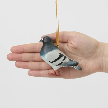 A hand-painted Rock Dove Pigeon Ornament, handmade in the Philippines with softly shaded details and a satin hanging ribbon.


A familiar city friend takes on old-world charm in our Rock Dove Pigeon Ornament. 
