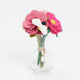 Sustainable floral decor with felt roses and bee accent in a miniature glass bud vase.