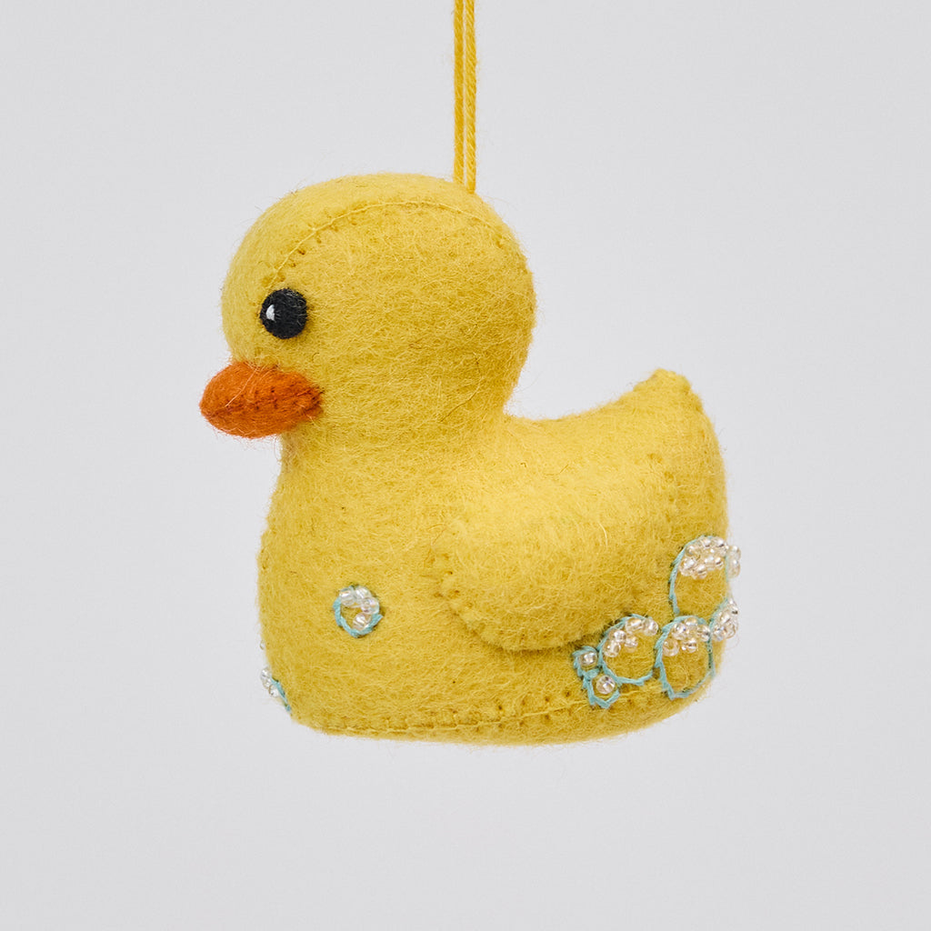 Handmade felt Rubber Duck ornament from Craftspring, featuring detailed embroidered and beaded soap bubbles—evoking childhood nostalgia and perfect for nursery decor and thoughtful baby shower gifting, ethically crafted by artisans using sustainable wool.