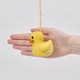 Handmade felt Rubber Duck ornament from Craftspring held in front of a hand to show size—featuring detailed embroidered and beaded soap bubbles, showcasing artisan craftsmanship and playful charm, ethically crafted by artisans using sustainable wool.