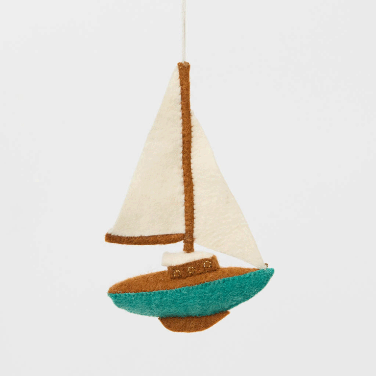 Set sail for holiday memories with our handcrafted Sailboat Ornament, a charming tribute to life on the water. Featuring crisp white sails, a warm wood-toned mast and deck, and a sea-glass-inspired turquoise hull, this classic sailboat captures the quiet beauty of coastal living and the freedom of open water.