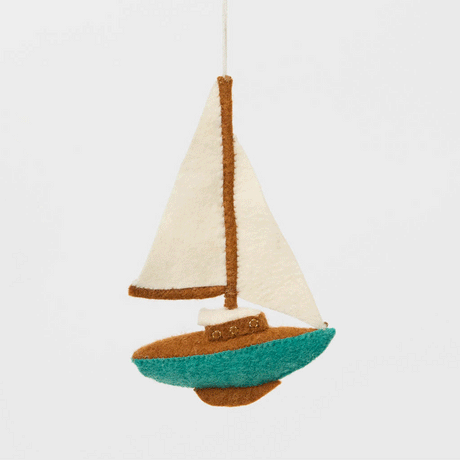 Set sail for holiday memories with our handcrafted Sailboat Ornament, a charming tribute to life on the water. Featuring crisp white sails, a warm wood-toned mast and deck, and a sea-glass-inspired turquoise hull, this classic sailboat captures the quiet beauty of coastal living and the freedom of open water.