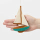 Set sail for holiday memories with our handcrafted Sailboat Ornament, a charming tribute to life on the water. Featuring crisp white sails, a warm wood-toned mast and deck, and a sea-glass-inspired turquoise hull, this classic sailboat captures the quiet beauty of coastal living and the freedom of open water.