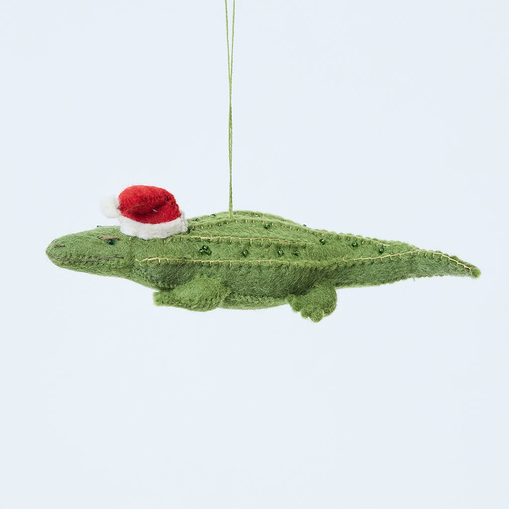 Craftspring’s Santa Alligator Ornament — felt alligator with a beautiful face and embroidered and beaded back ridges — heirloom-quality Christmas ornament, perfect for holiday gifting, ethically crafted by artisans using sustainable wool.