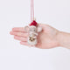 Craftspring’s Santa Mouse with Cookie Ornament displayed in front of a hand to show its size — needle felted mouse with a cute face and whiskers, wearing a knitted Santa hat and holding a cookie, a charming heirloom-quality piece for Christmas gifting — ethically crafted by artisans using sustainable wool.