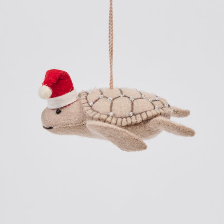 Handmade felt Santa Neutral Sea Turtle ornament from Craftspring, featuring intricate beaded and embroidered details and a red Santa hat—heirloom-quality Christmas decor, ethically crafted by artisans using sustainable wool.