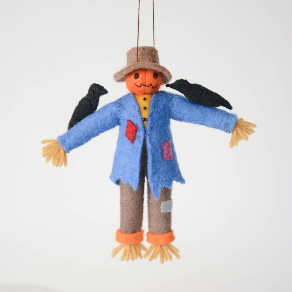 Under the bright full moon, our pumpkin scarecrow is too cute to scare. With two black crows on its shoulders and patches on its clothes, it's our favorite autumnal field-hand. Tie it to a trick-or-treating pumpkin, nestle it on a shelf, or add it to a tree for some Halloween fun!