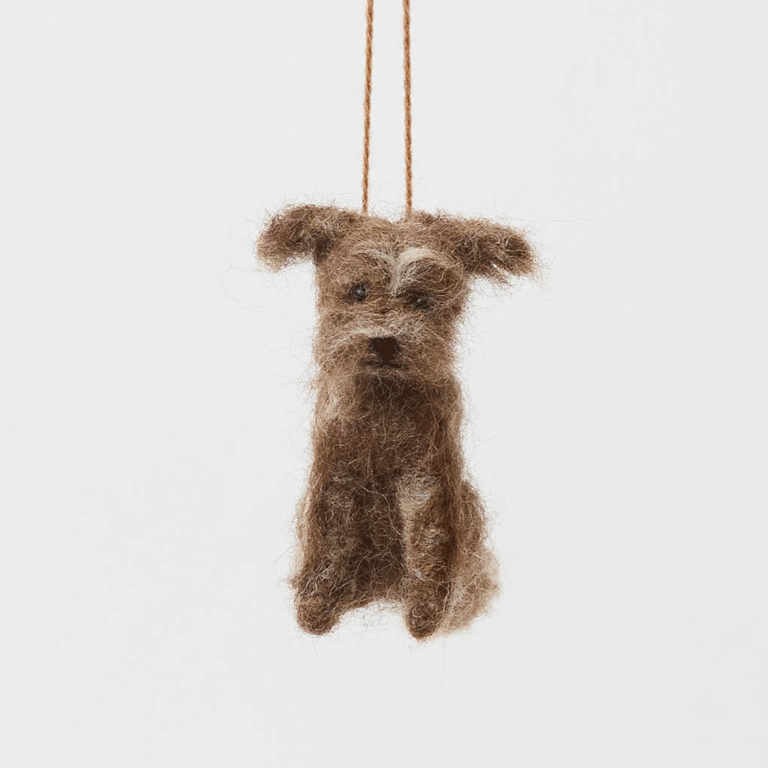 Celebrate the one-of-a-kind charm of man’s best friend with our felt Scruffy Mutt Ornament. Handcrafted by skilled artisans, this adorable pup features a tousled coat, floppy ears, and a sweet, soulful expression that captures the personality of beloved mixed-breed dogs everywhere.