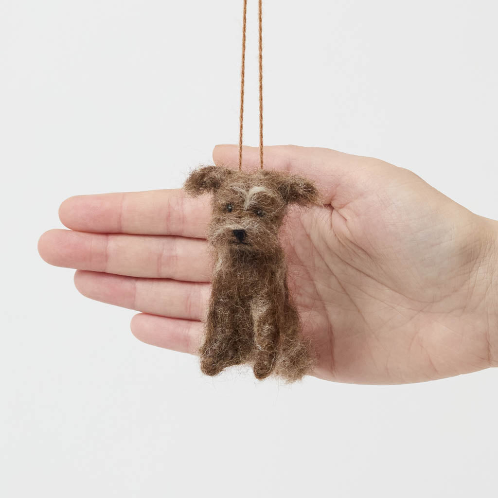 Celebrate the one-of-a-kind charm of man’s best friend with our felt Scruffy Mutt Ornament. Handcrafted by skilled artisans, this adorable pup features a tousled coat, floppy ears, and a sweet, soulful expression that captures the personality of beloved mixed-breed dogs everywhere.