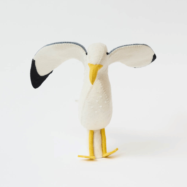 Let your holiday décor take flight with our handcrafted Seagull Tree Topper, a whimsical coastal alternative to the traditional star or angel. With wings fully outstretched, bright yellow legs, and classic black-tipped feathers, this charming seabird captures the freedom and beauty of life by the ocean.