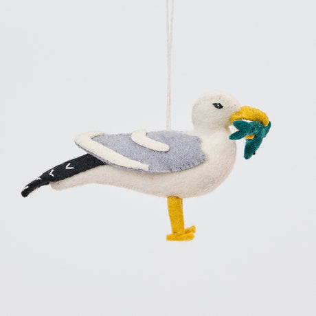 Handmade felt Seagull ornament from Craftspring, featuring detailed embroidery and a fish in its beak—heirloom-quality Christmas decor perfect for nautical lovers, sustainably handmade by artisans using wool.