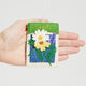 Soft felt ornament styled like a seed packet, featuring a love message and gentle bell sounds
