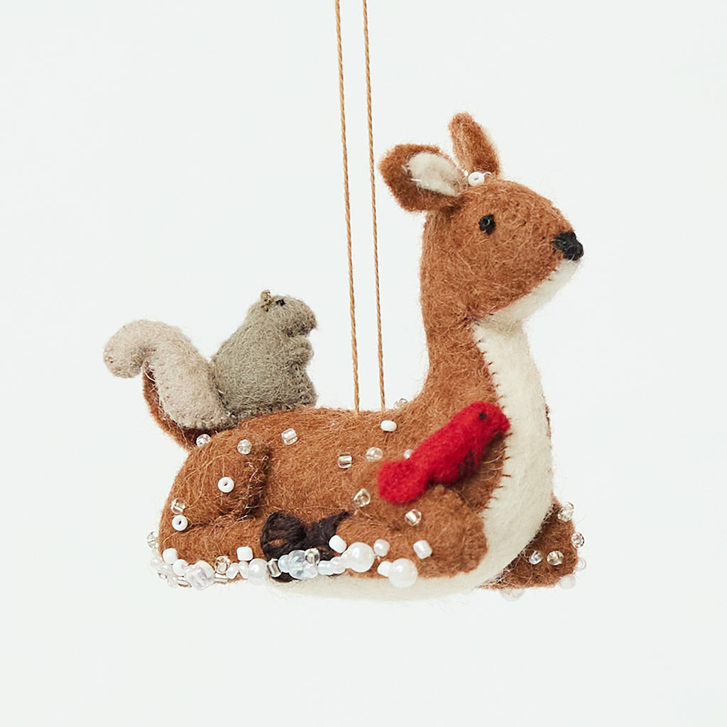 Handmade felt Sitting Deer with Friends Ornament from Craftspring, featuring a deer surrounded by a rabbit, squirrel, and bird with beaded snow and embroidered details—heirloom-quality Christmas decor, ethically crafted by artisans using sustainable wool.