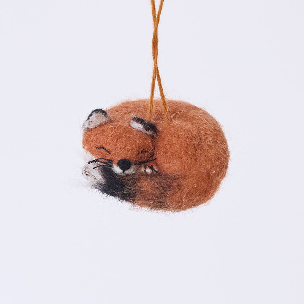 Craftspring’s Sleepy Fox Ornament — needle felted, curled up with a cute face, fluffy tail, and delicate whiskers, this handmade ornament adds cozy charm to holiday décor — heirloom-quality Christmas ornament, ethically crafted by artisans using sustainable wool.