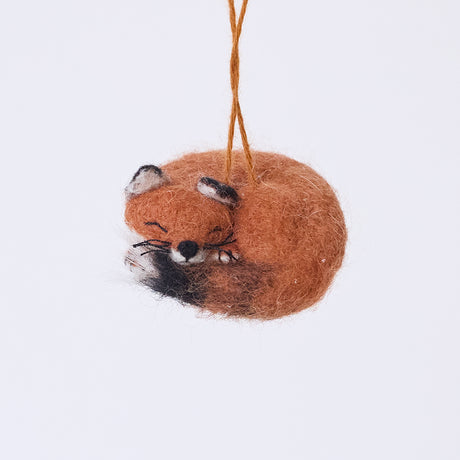 Craftspring’s Sleepy Fox Ornament — needle felted, curled up with a cute face, fluffy tail, and delicate whiskers, this handmade ornament adds cozy charm to holiday décor — heirloom-quality Christmas ornament, ethically crafted by artisans using sustainable wool.