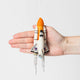 Felt space shuttle ornament for kids, future astronauts, and science lovers. Handmade wool holiday decoration with rocket and embroidery detail.