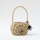 A hand-crocheted raffia Spider Basket featuring a bold black spiderweb and playful spider detail, perfectly sized for trick-or-treating, Halloween treasures, and festive fall displays.