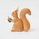 Our Squirrel Tree Topper is a handmade wool felt Christmas decoration featuring a beautifully embroidered bushy tail and golden beaded acorn, designed to perch atop your holiday tree or stand on its own as whimsical woodland décor.