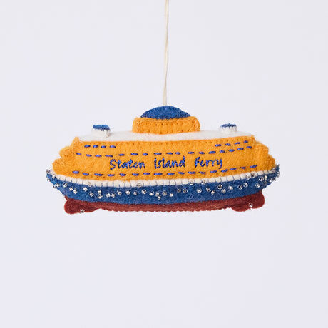 Handmade felt Staten Island Ferry ornament from Craftspring, featuring intricate embroidered details and beaded waves, showcasing the iconic orange ferry—heirloom-quality Christmas decor, ethically crafted by artisans using sustainable wool.