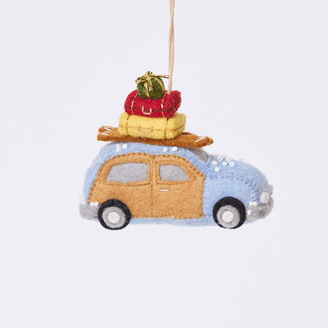 Craftspring’s Station Wagon with Luggage Ornament rotating to show front, side, and back views — felt blue station wagon carrying suitcases, skis, and presents on top, with beaded snow details, a whimsical ornament perfect for holiday gifting — heirloom-quality Christmas decor, ethically crafted by artisans using sustainable wool.