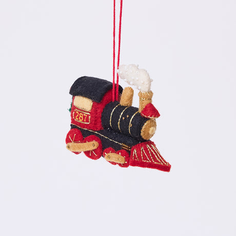 Craftspring’s Steam Engine Train Ornament — felt black and red train with gold embroidery and beading, fluffy steam coming out the top, and a wreath on the back — heirloom-quality Christmas ornament, perfect for holiday gifting, ethically crafted by artisans using sustainable wool.