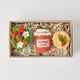 Strawberry-themed felt ornament gift set in a kraft box with crinkle paper. Includes a felt strawberry pint, strawberry jam jar, and strawberry pancake stack. Handmade from natural wool felt using traditional needle-felting. Fair trade and ready to hang.