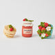 Strawberry-themed felt ornament gift set in a kraft box with crinkle paper. Includes a felt strawberry pint, strawberry jam jar, and strawberry pancake stack. Handmade from natural wool felt using traditional needle-felting. Fair trade and ready to hang.