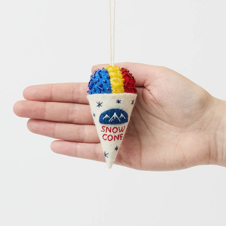 Cool off your Christmas tree with our Summer Snow Cone Ornament, a cheerful felt ornament inspired by one of summer’s most iconic frozen treats. Handcrafted by skilled artisans using traditional felting techniques, this whimsical ornament features a vibrant tri-color snow cone topped with sparkling bead accents that mimic crunchy ice crystals. The detailed white cone is embroidered with classic snow cone graphics and playful lettering, capturing the carefree spirit of amusement parks, beach vacations, and s